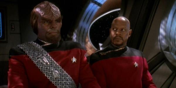 Worf stares off camera while DS9 crew member looks at him questio<em></em>ningly 